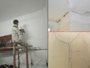 Một công nhân đang kiểm tra và sửa chữa vết nứt trên tường của tòa nhà bằng keo chống thấm. Hình ảnh nhấn mạnh vào việc bảo trì định kỳ để ngăn ngừa thấm nước và hư hại cấu trúc.